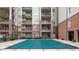 Building exterior showing a well-maintained pool area surrounded by lush landscaping and balconies at 50 Biscayne Nw Dr # 2111, Atlanta, GA 30309