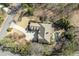 Aerial view of a home showcasing its sprawling lot, private pool area, and circular driveway at 5284 Vernon Springs Trl, Sandy Springs, GA 30327