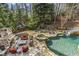 Entertainer's backyard with pool, water slide, hot tub, fireplace, playhouse, and mature landscaping at 5284 Vernon Springs Trl, Sandy Springs, GA 30327