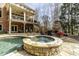 This backyard has a stone hot tub and in-ground pool, with an outdoor fireplace and balcony at 5284 Vernon Springs Trl, Sandy Springs, GA 30327