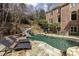 Luxury home with pool, water slide, outdoor lounge area, and beautifully landscaped grounds at 5284 Vernon Springs Trl, Sandy Springs, GA 30327