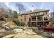 Backyard features a pool, hot tub, outdoor seating, and a multi-story brick home at 5284 Vernon Springs Trl, Sandy Springs, GA 30327