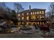 Backyard with pool, spa, patio, outdoor seating, and a large brick home creates a relaxing atmosphere at 5284 Vernon Springs Trl, Sandy Springs, GA 30327