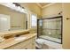 Well-lit bathroom featuring tile flooring, vanity with a large mirror, and a separate tub at 5284 Vernon Springs Trl, Sandy Springs, GA 30327