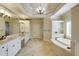 Spa-like bathroom with dual vanities, a soaking tub, and a large framed mirror at 5284 Vernon Springs Trl, Sandy Springs, GA 30327