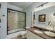 Bathroom featuring a light blue accent wall, granite vanity and a glass enclosed shower at 5284 Vernon Springs Trl, Sandy Springs, GA 30327