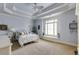Blue bedroom featuring a trey ceiling, and large windows with shutters at 5284 Vernon Springs Trl, Sandy Springs, GA 30327