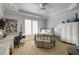 Well-lit bedroom featuring blue walls, trey ceilings and large windows with shutters at 5284 Vernon Springs Trl, Sandy Springs, GA 30327