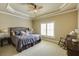 Neutral bedroom with sitting area features a ceiling fan and classic trim work at 5284 Vernon Springs Trl, Sandy Springs, GA 30327