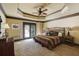 Bedroom featuring a ceiling fan, neutral walls, carpet floors, and an outside view at 5284 Vernon Springs Trl, Sandy Springs, GA 30327