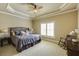 Comfortable bedroom featuring a decorative ceiling, fan, and plush carpeting at 5284 Vernon Springs Trl, Sandy Springs, GA 30327