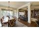 Open dining room featuring a wooden table, large windows, and hardwood floors overlooking the living area at 5284 Vernon Springs Trl, Sandy Springs, GA 30327