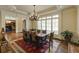 Elegant dining room featuring a chandelier, large windows, and rich hardwood floors at 5284 Vernon Springs Trl, Sandy Springs, GA 30327