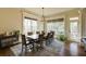 Bright dining room with large windows, modern chandelier and wooden table at 5284 Vernon Springs Trl, Sandy Springs, GA 30327