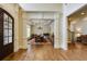 Inviting entryway with hardwood floors, decorative columns, and a view into the formal dining room at 5284 Vernon Springs Trl, Sandy Springs, GA 30327
