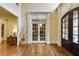 This grand foyer features hardwood floors, double doors, and decorative millwork at 5284 Vernon Springs Trl, Sandy Springs, GA 30327