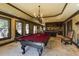 Large game room featuring a pool table, access to outside, and a wet bar with stools at 5284 Vernon Springs Trl, Sandy Springs, GA 30327