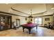 Spacious game room featuring a pool table, chandelier lighting and access to outside at 5284 Vernon Springs Trl, Sandy Springs, GA 30327