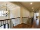 Hallway with a beautiful chandelier, hardwood floors, and a staircase at 5284 Vernon Springs Trl, Sandy Springs, GA 30327