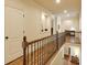 Hallway with wood floors, wood and iron banister, and trim carpentry throughout at 5284 Vernon Springs Trl, Sandy Springs, GA 30327