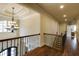 Well-lit hallway featuring beautiful trim work, hardwood floors, and elegant chandelier at 5284 Vernon Springs Trl, Sandy Springs, GA 30327