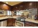 Gourmet kitchen featuring stainless steel appliances, granite countertops, and dark wood cabinets at 5284 Vernon Springs Trl, Sandy Springs, GA 30327