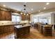 Open kitchen with a large island, granite countertops, and stainless steel appliances at 5284 Vernon Springs Trl, Sandy Springs, GA 30327