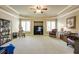 Spacious living room featuring carpet, a ceiling fan, and windows with shutters at 5284 Vernon Springs Trl, Sandy Springs, GA 30327