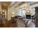 Comfortable living room featuring a fireplace, piano, large windows, and hardwood floors at 5284 Vernon Springs Trl, Sandy Springs, GA 30327