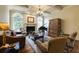Cozy living room featuring a fireplace, piano, and ample seating at 5284 Vernon Springs Trl, Sandy Springs, GA 30327