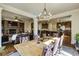 Inviting open-concept living space showcasing a stone fireplace, modern lighting, and seamless flow into the kitchen at 5284 Vernon Springs Trl, Sandy Springs, GA 30327