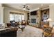 Cozy living room featuring a stone fireplace, custom built-ins, and large windows for abundant natural light at 5284 Vernon Springs Trl, Sandy Springs, GA 30327
