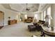 Bright main bedroom featuring a tray ceiling, carpeted floors, and a seating area at 5284 Vernon Springs Trl, Sandy Springs, GA 30327