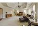 Large primary bedroom suite featuring a coffered ceiling, seating area, and rustic wood furniture at 5284 Vernon Springs Trl, Sandy Springs, GA 30327