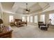 Serene bedroom with a tray ceiling, generous windows, and ample space for a seating area at 5284 Vernon Springs Trl, Sandy Springs, GA 30327