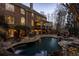 Stunning backyard oasis with a stone pool, waterfall features, slide and outdoor fireplace for elegant entertaining at 5284 Vernon Springs Trl, Sandy Springs, GA 30327