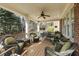 Spacious porch featuring comfortable wicker furniture, ceiling fan, and views of lush greenery at 5284 Vernon Springs Trl, Sandy Springs, GA 30327