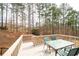 Inviting back deck with outdoor dining set, ideal for enjoying the wooded surroundings at 426 Highcrest Dr, Acworth, GA 30101