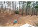 Expansive backyard with lush trees and a swing set, perfect for outdoor activities at 426 Highcrest Dr, Acworth, GA 30101