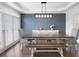 Elegant dining room featuring a modern chandelier, hardwood floors, and large windows for natural light at 426 Highcrest Dr, Acworth, GA 30101
