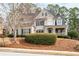 Beautiful two-story home featuring a well-maintained lawn, mature trees, and classic architectural details at 426 Highcrest Dr, Acworth, GA 30101
