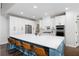 Kitchen with large island, seating, white cabinets, stainless appliances, and hardwood floors at 426 Highcrest Dr, Acworth, GA 30101