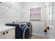 Practical laundry room with modern washer and dryer and ample storage space at 426 Highcrest Dr, Acworth, GA 30101