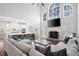 Open-concept living room with fireplace, tall windows, and a blue kitchen island, creating a perfect gathering space at 426 Highcrest Dr, Acworth, GA 30101