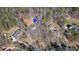 Aerial view of a wooded lot with a two-story house and driveway access on a private cul-de-sac at 582 Black Forest Run, Douglasville, GA 30134