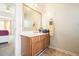 Vanity area in a bathroom with a mirror and wood cabinet at 582 Black Forest Run, Douglasville, GA 30134