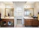 View of the vanity areas and bathroom in a primary bedroom suite at 582 Black Forest Run, Douglasville, GA 30134