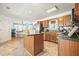 Cozy kitchen featuring custom wood cabinets, a stainless steel refrigerator, and a center island at 582 Black Forest Run, Douglasville, GA 30134