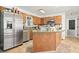 Cozy kitchen featuring custom wood cabinets, a stainless steel refrigerator, and a center island at 582 Black Forest Run, Douglasville, GA 30134
