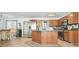 Cozy kitchen featuring custom wood cabinets, a stainless steel refrigerator, and a center island at 582 Black Forest Run, Douglasville, GA 30134